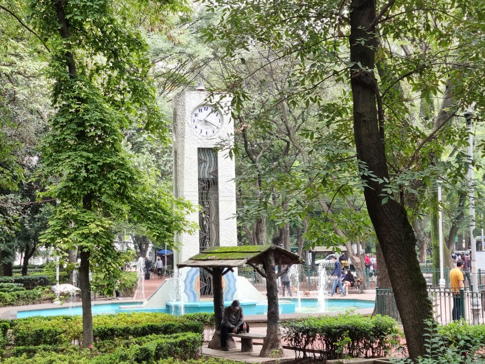 Reloj público en un parque con árboles